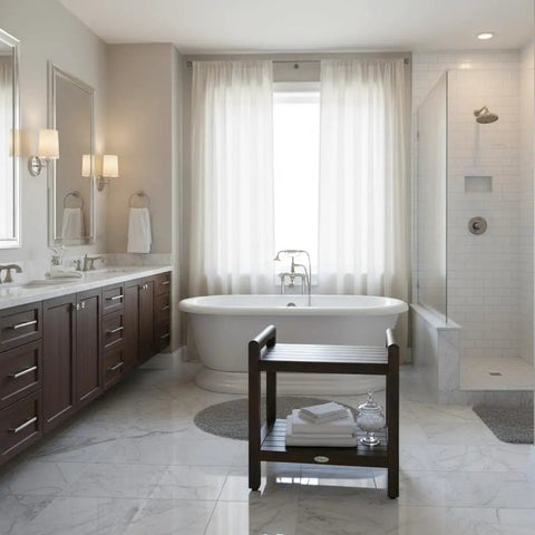 Elegant bathroom with 24 Inch Teak Shower Bench With LiftAide Arms, placed beside freestanding tub, showcasing storage shelf.