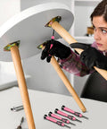 Woman assembling table with Compact 39 Piece Hand Tool Kit With Case For DIYers And Homeowners A Handy Starter Set in pink.