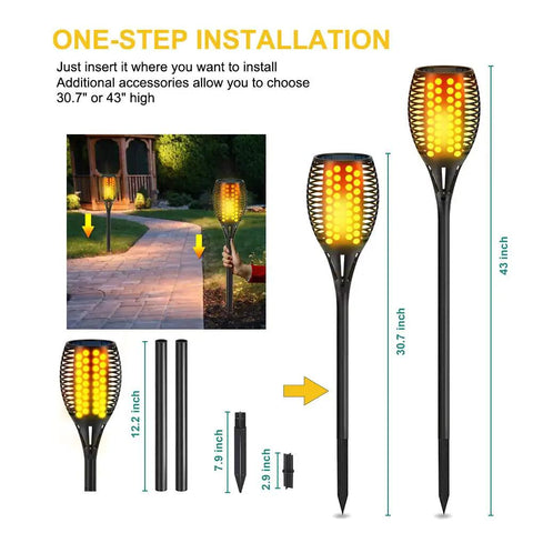 4 Pack 43 Inch Solar Torch Lights With 96 LEDs, Outdoor Waterproof Landscape Pathway Lighting, Realistic Flickering Flame Effect For Patio Vibes, Dusk To Dawn Auto On Off, Yard Garden Decor installed along a garden path.
