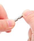 Two stainless steel PCB standoff spacers with threaded center, held between fingers for electronics assembly