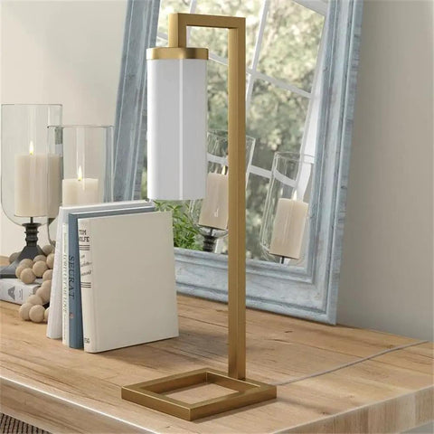 Tall Floor Lamp With Glass Milk Shade In Brass Finish, Stands At 67.75 Inches Tall, Steel Base on wooden table near mirror