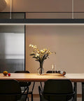 Top Shelf 4 Ft Linear Led Pendant Light With Smooth Remote Control Adjustable 3000K To 6000K Color Temperature Killer Glow For Offices Shops And Home Modern Black Housing in a modern dining area.