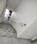 Crystal Clear Acrylic Stair Handrail With Rock Solid Silver Wall Mount Brackets Custom Length Non Slip Transparent Safety Railing For Buttery Smooth Daily Walks on stairway with marble steps.