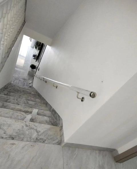 Solid As A Rock Clear Acrylic Stair Handrail With Heavy Duty Stainless Brackets And Grip Tight Surface Custom Lengths For Secure Wall Mount in a home stairway.