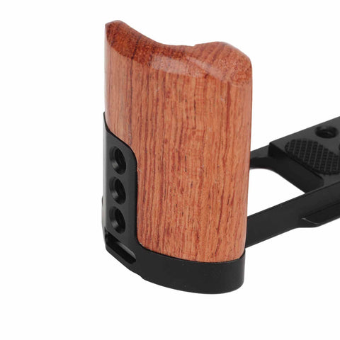 Close-up of wood handle on aluminum camera cage rig with 1/4 inch and 3/8 inch screw holes, cold shoe mount, vertical video mounts