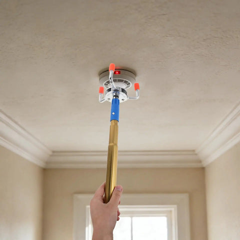 Using Heavy Duty Aluminum Alloy Smoke Sensor Disassembler Tool For Office Checks to reach a smoke detector on the ceiling.