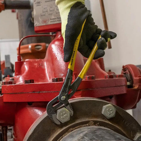 Worker using 12 Inch Quick Adjust Pump Pliers With Tongue And Groove Klaw Push Button Ratchet For Fast Adjustments on a red valve