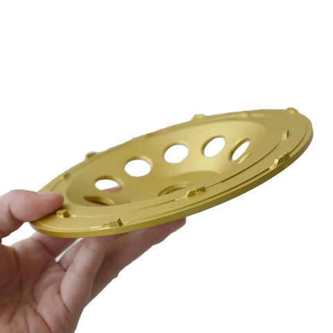 Close-up of 7 Inch Double Row PCD Cup Wheel in hand, showcasing design for Beastly Concrete Coatings Removal and Surface Prep. 12-piece set.