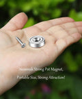 Hand holding Heavy Duty Neodymium Mounting Magnets With Screws, 40 Lbs Holding Power, Countersunk Holes, silver round magnet.