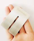 Hand holding metallic component of Punching Pad Kit For Leather Work With Yellow Cushioned Protective Mat And White Cutting Board