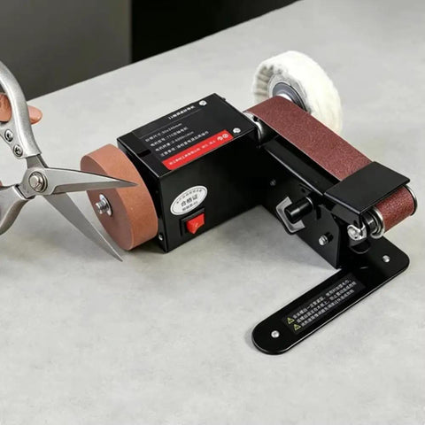 Badass Compact Desktop Electric Belt Sander Set For Sharpening Knives Metal Parts And Wood Projects With Adjustable Speed Settings and Comfortable Grip on workbench.