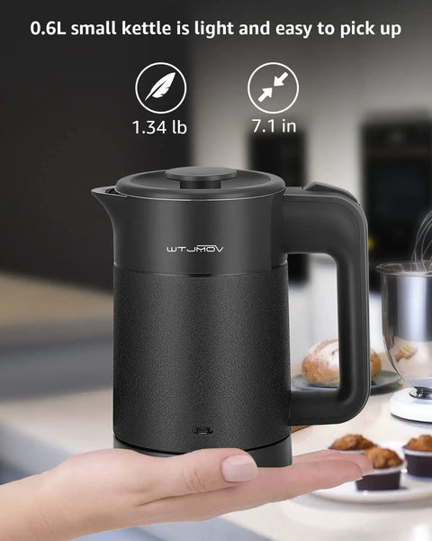 Grab And Go 0.6L Electric Kettle For Travel Ultralight 1.34lb 600W Fast Boil Double Wall Stainless Steel Auto Shut Off Portable Tea And Coffee Kettle Black shown on a hand.