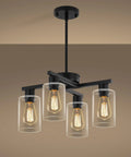 Sleek Modern Black Four Light Farmhouse Chandelier Featuring Crisp Cylindrical Glass Shades, adjustable height pendant light over a tan wall.