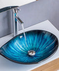 Modern Oval Glass Vessel Sink With Blue Line Stripes, Slick Countertop Washbasin Built On Badass Toughened Glass with water stream.
