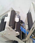 High Speed Round Bottle Labeling Machine Plus Slick Date Printer and Rock Solid Applicator showing rollers and motors, designed for heavy duty beverage containers.