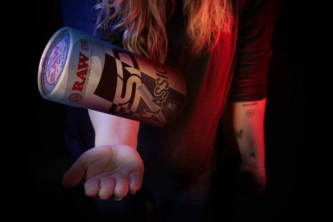 Hand holding a Classic King Size Pre Rolled Cones 100 Pack With Tips And Packing Tubes Included, RAW branded packaging.