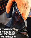 Anti Fog And Scratch Resistant Safety Glasses For Construction Pros And Everyday Workers On The Job With Tinted Lenses ANSI Z87 ISEA Certified Eye Protection For Men And Women Durable Lightweight Comfort Pack Of 12 held by person wearing gloves