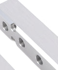 Close-up of aluminum block from Durable Two Pack Air Manifold Kit With Five Way Seven Port Design, showing multiple NPT outlets.