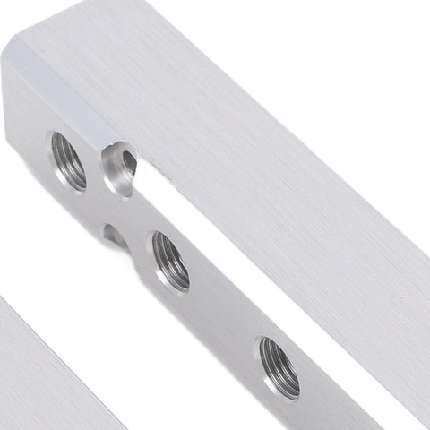 Close-up of aluminum Five Way Seven Port Pneumatic Manifold with half inch NPT supply and quarter inch NPT output ports for compressor.
