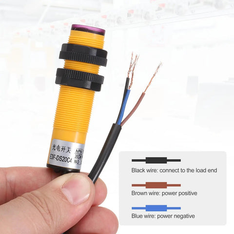 Diffuse Reflection Photoelectric Sensor M18 Three Line Detection, 7 To 20 Cm Range, held with visible wires and label.