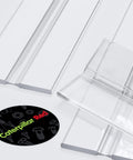3 Pack Clear Acrylic Flexible Living Hinges 300mm Continuous Strip showing transparent hinges on a gray surface.