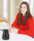Woman with Portable Turkish Coffee Pot 600ml Electric Kettle With Removable Anti Scald Handle For Heating Coffee Tea Milk
