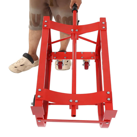 Beefy Steel Drum Cradle With Dependable Rolling Wheels And Fold Back Dump Bar For Serious Fifty Five Gallon Vessel Hauling and Zero Sweat Liquid Transferring On Any Commercial Site, viewed from front with handle and wheels.