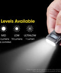 Hand holding Ultra Compact 500 Lumen Dual LED Keychain Light With Rechargeable Battery OLED Display Dual Switch Black Finish
