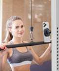 Gym Ready Magnetic Phone Holder With Alloy Base And Ball Joint Attaches To Metal Surfaces Dual Magnetic Mount For MagSafe iPhone 12 13 14 15 16 17 And Android With Metal Ring Secure Grip installed on gym equipment holding phone.