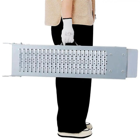 Person holding 71 Inch Folding Steel Loading Ramps With Non Slip Surface And Carry Handle For Truck Trailer And Equipment Heavy Duty Set