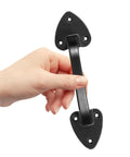 Hand holding a 3 Pack Heavy Duty Cast Iron Barn Gate Handle With Aged Iron Finish And Smooth Curvature