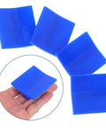 Close-up of blue plastic puller tabs from 4 Piece Auto Dent Repair Kit with Plastic and Metal Puller Tabs, shown in hand for size reference.