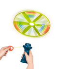 Skyrocopter Light Up Flying Disc With Launcher For Kids 5 And Up, Disco Flyer That Shines At Night being launched with a blue handle