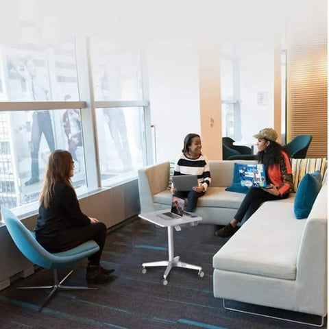 Game Changer Adjustable Lectern Podium Stand With Smooth Wheels in a modern meeting space for collaborative discussions.