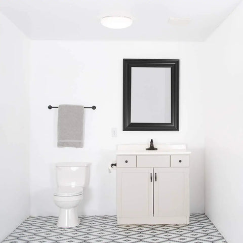 Bathroom Exhaust Fan 70 CFM Quiet 2.0 Sones ceiling mounted, white finish shown in small bathroom with mirror and vanity.