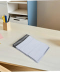 White Poly Mailers 10x14 Inch Waterproof Self Seal Shipping Bags for Apparel on a desk