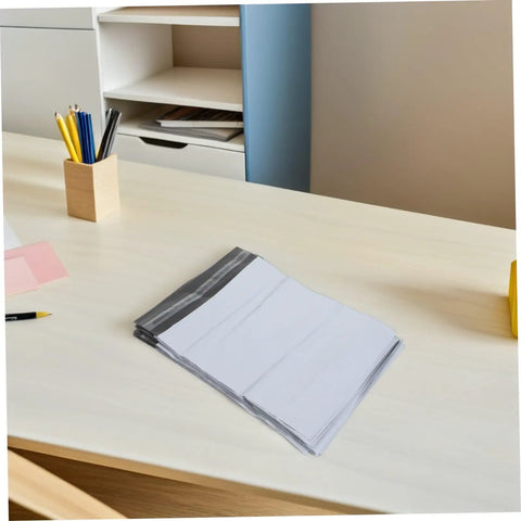 White Poly Mailers 10x14 Inch Waterproof Self Seal Shipping Bags for Apparel on a desk