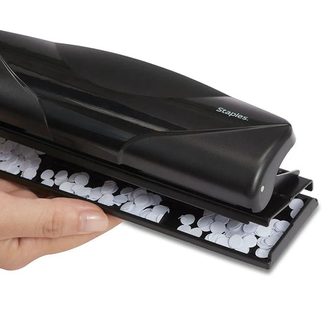 Close-up of a black portable Mini 3 Hole Punch, 6 sheet capacity, showing clean circular hole punches for office or school use.