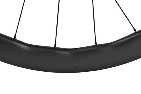 Close-up of carbon fiber wheelset for road bikes 700c disc brake tubeless 50 by 28mm UD matte black decals ultralight and ultra strong