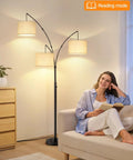 Woman reading beside Arched LED Floor Lamp With Three Lights, 81 Inch Tall Mid Century Style with Beige Lampshade in living room