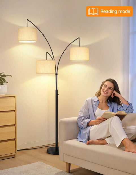 Woman reading beside Arched LED Floor Lamp With Three Lights, 81 Inch Tall Mid Century Style with Beige Lampshade in living room
