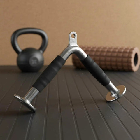 Triceps Training Bar For Cable Pulldown And Pressdown Sturdy Rubber Grip Bar on gym mat with kettlebell and foam roller background.