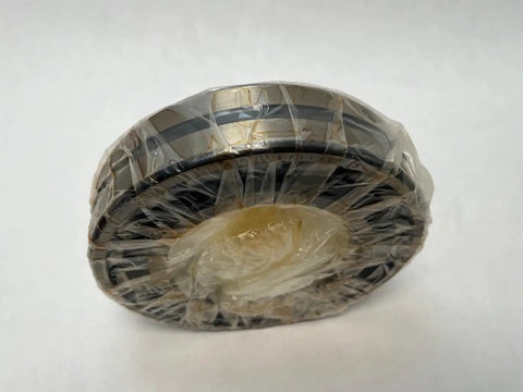 22216 Spherical Roller Bearing With 80mm Inner Diameter and 140mm Outer Diameter Measuring 33mm Wide wrapped in plastic for protection.