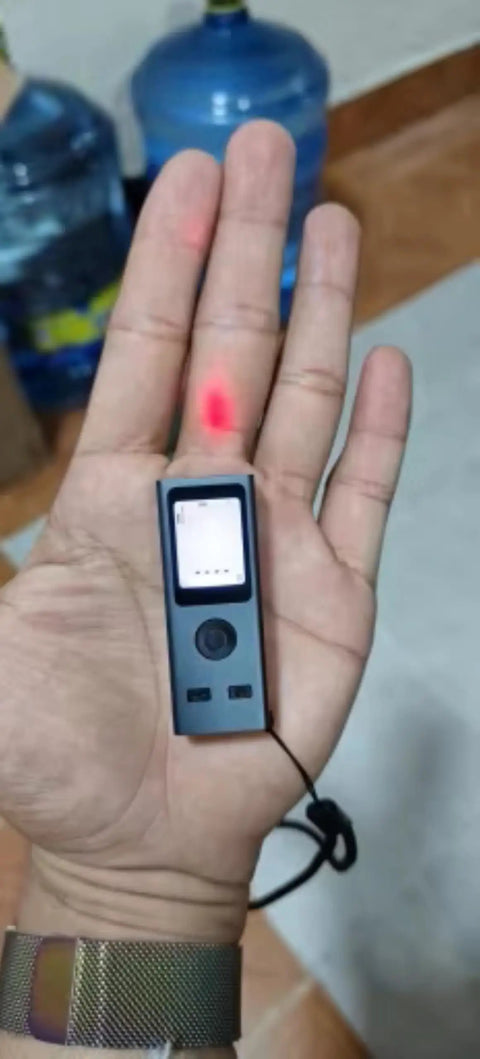 Pocket Size Laser Distance Meter 164 Ft Range USB Rechargeable held in hand showing LCD screen and laser pointer