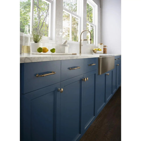 Reeded 7 Inch Center-To-Center Bar Pull In Honey Bronze, on blue kitchen cabinets with marble countertop