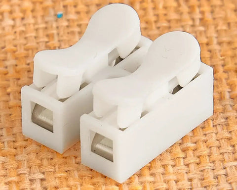 Solid VCM Bypass Harness And Resistor Plug Set For 3.5L V6 Engine showing white connector plugs on textured background.