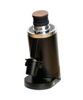 Top Shelf Single Dose Coffee Grinder Equipped With 83Mm Red Titanium Flat Burrs And Integrated Plasma Ionizer Chute For Zero Static Clumps Ideal For Home Brew Crews Chasing Consistent Pulls Without Any Headache In Classic Black, showing side view with wooden top.