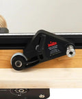 Heavy Duty Flex Stock Guides For Table Saws And Router Tables with smooth rollers on a wood surface.