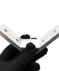 Gloved hand holding an L-shaped 10 Pack 1 Inch Slot Aluminum Corner Bracket For 1010 And 2525 Extrusions, showing 4 bolt holes for DIY frames.