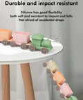 Game Changing BPA Free Silicone Toy Train For The Kiddos Push And Pull Stacking Blocks in soft colors on a table edge.